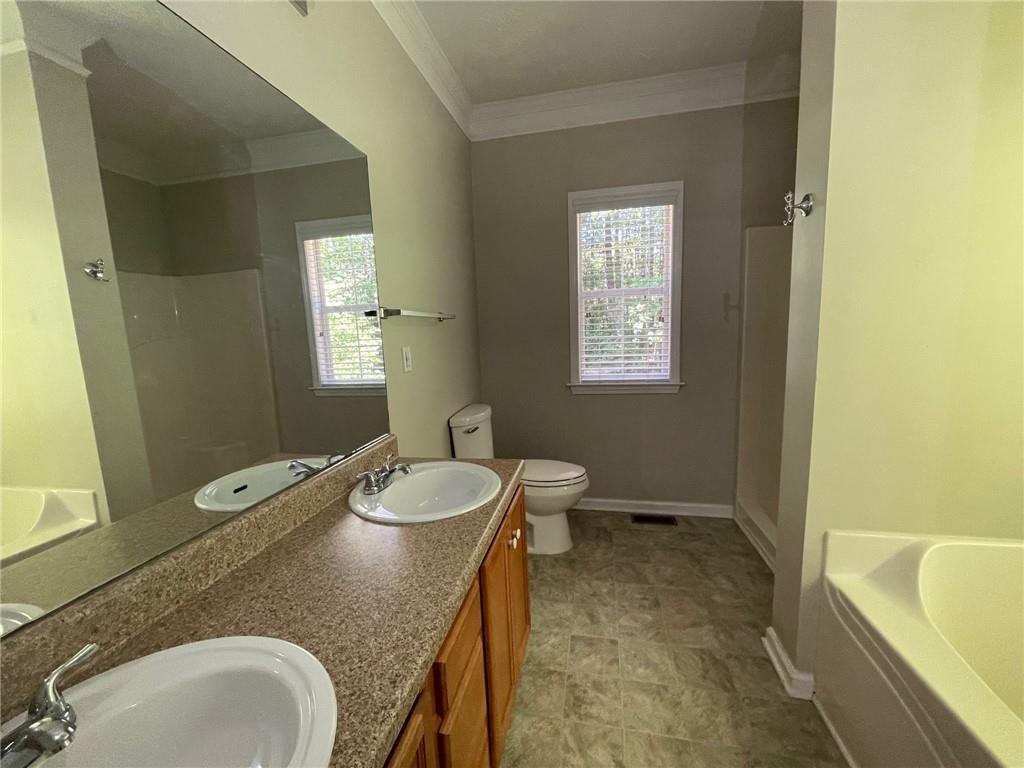 95 Luke Drive Dallas, GA 30132 - Photo 10 of 15 a spacious bathroom with a granite countertop sink and a mirror