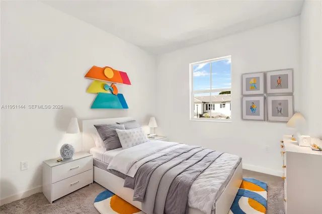 a bedroom with bed and painting on the wall