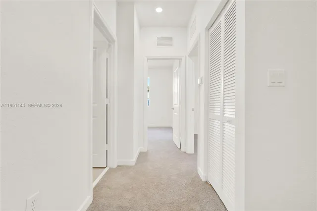 a view of a bathroom with white walls