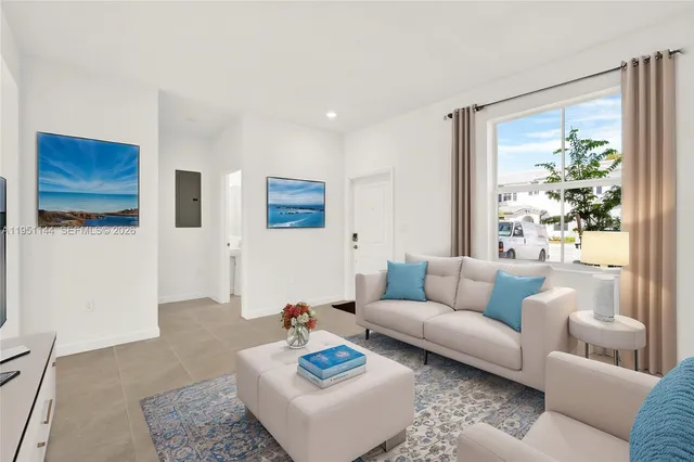 a living room with furniture and a large window