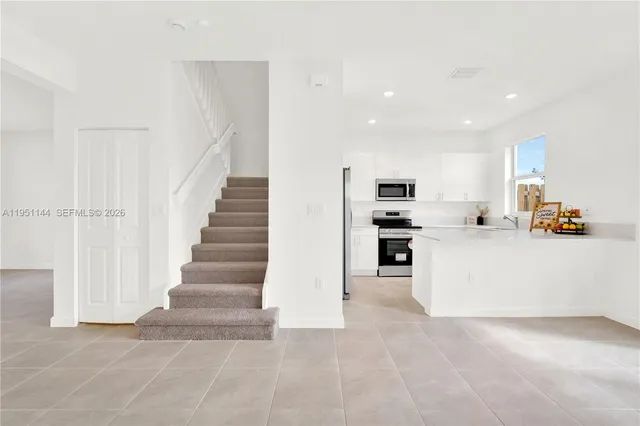 a view of kitchen with furniture and microwave