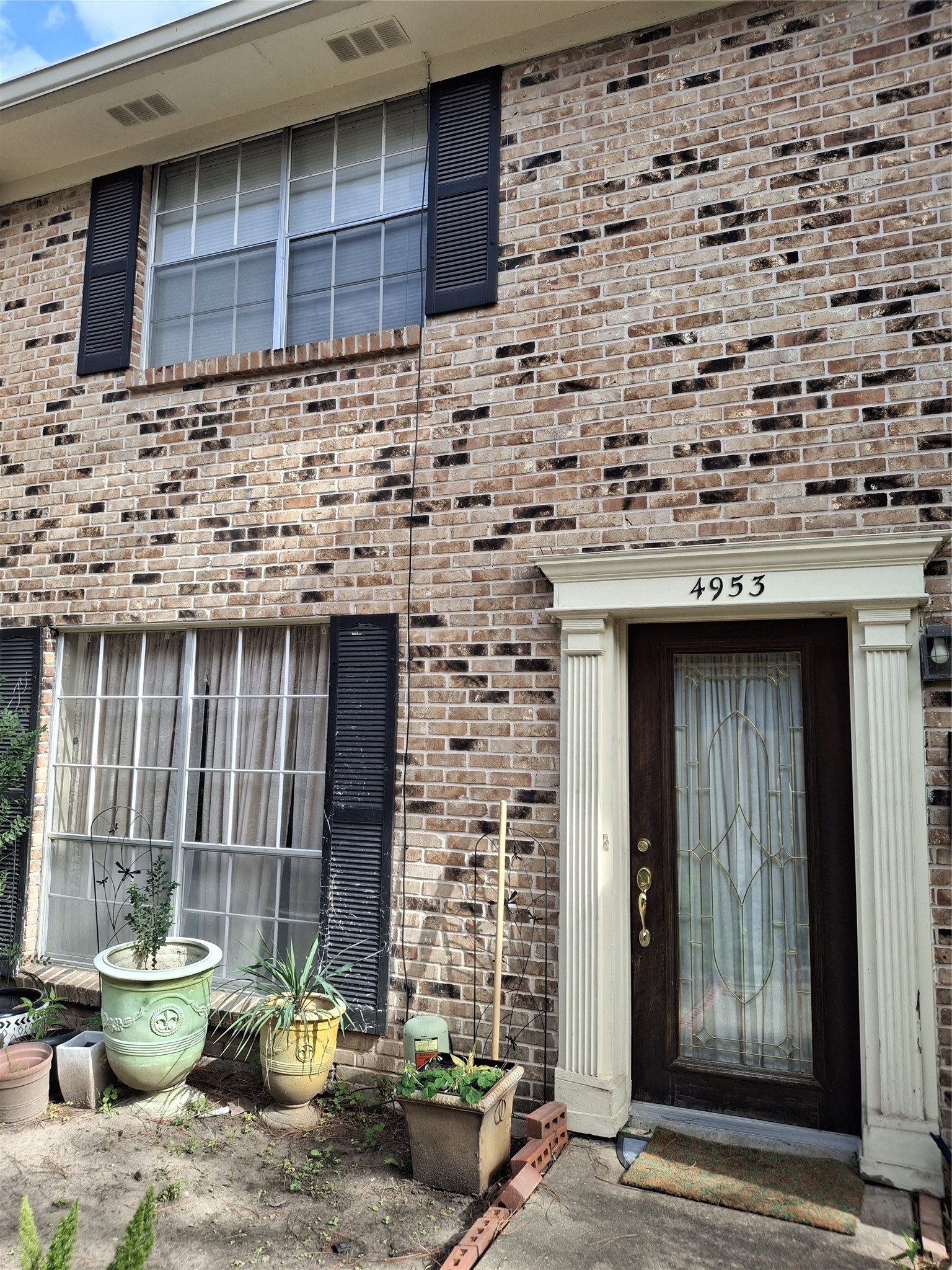 a front view of a house with outdoor seating