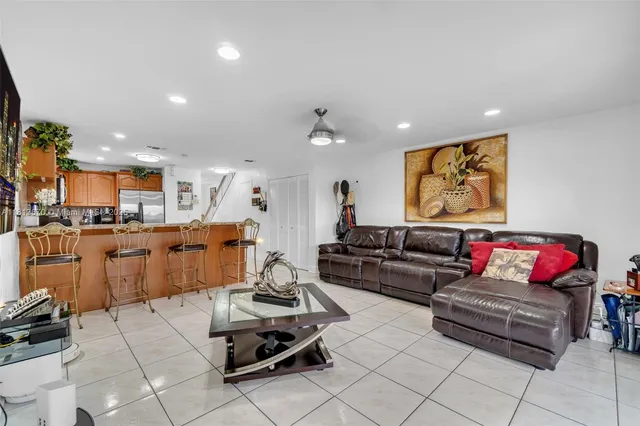 a living room with furniture kitchen view and a couch