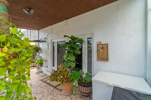 a outdoor dining space with a table and chairs