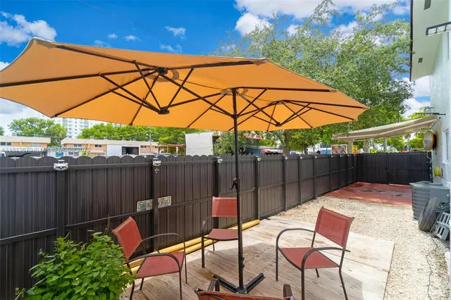 a patio with table and chairs
