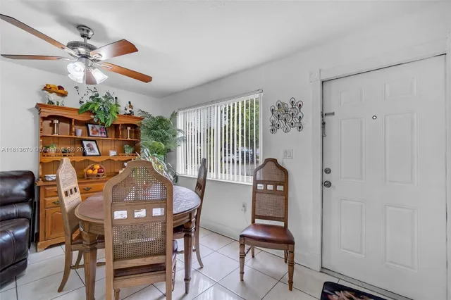 a dining room with furniture and window