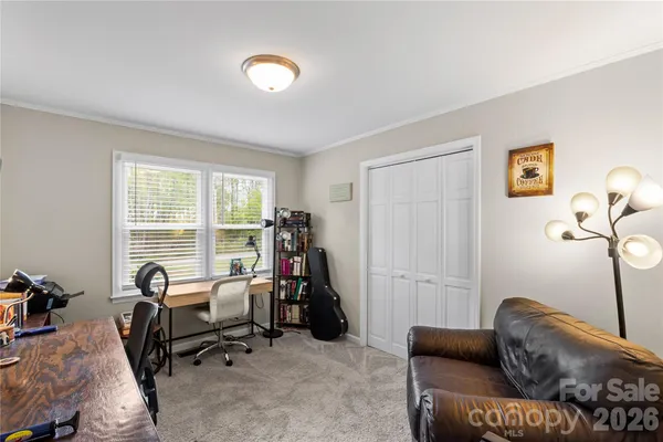 a livingroom with workspace and a window