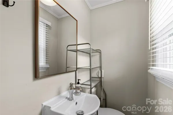 a bathroom with a sink mirror and toilet