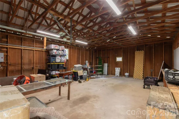 a living room with furniture gym equipment and a view of the shop