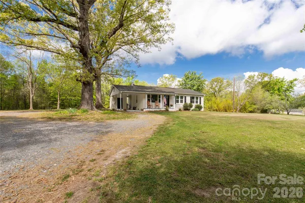 a front view of house with yard and green space