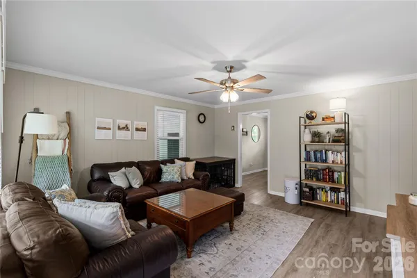 a living room with furniture and a bookshelf