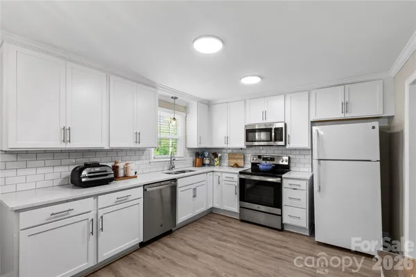a kitchen with a white cabinets and white appliances