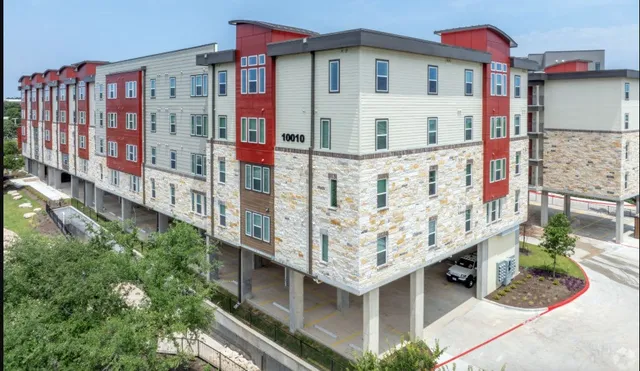 an aerial view of multiple houses with yard