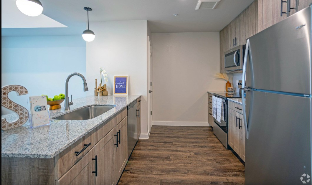 10010 North Capital Of Texas Highway Austin, TX 78759 - Photo 15 of 22 a kitchen with stainless steel appliances granite countertop a sink and a refrigerator