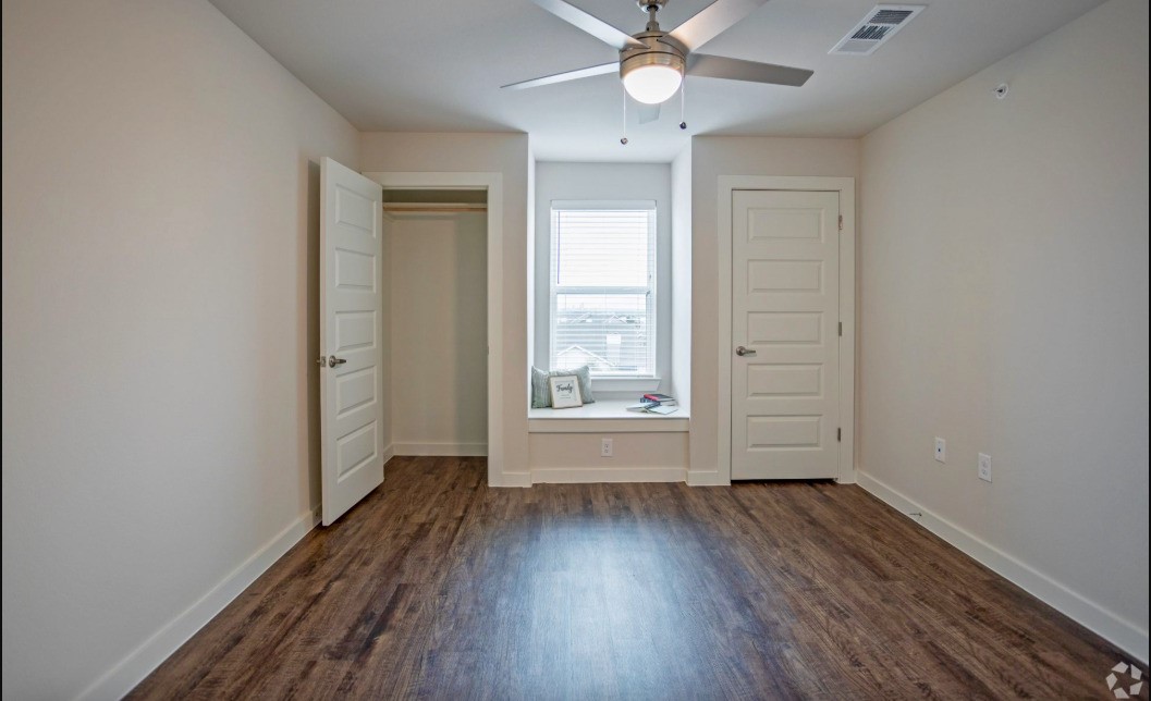 10010 North Capital Of Texas Highway Austin, TX 78759 - Photo 19 of 22 an empty room with wooden floor fan and windows