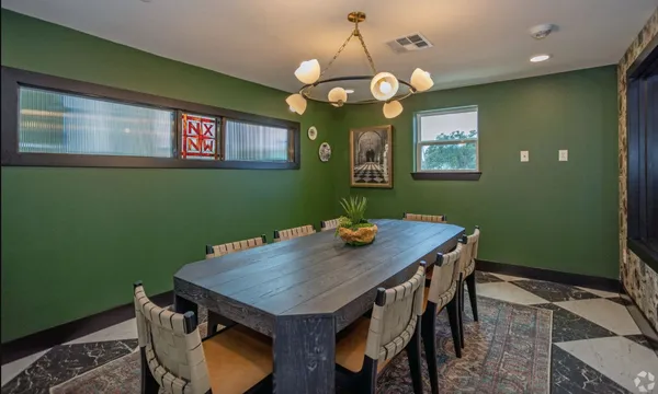 a balcony with table and chairs