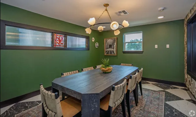 a balcony with table and chairs