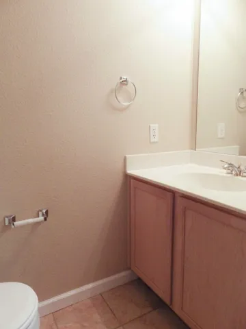 a bathroom with a sink a toilet and mirror