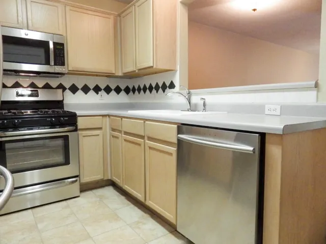 a kitchen with granite countertop a sink and a stove top oven