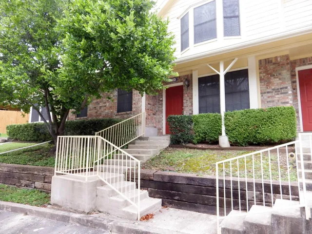 a front view of a house with a fence