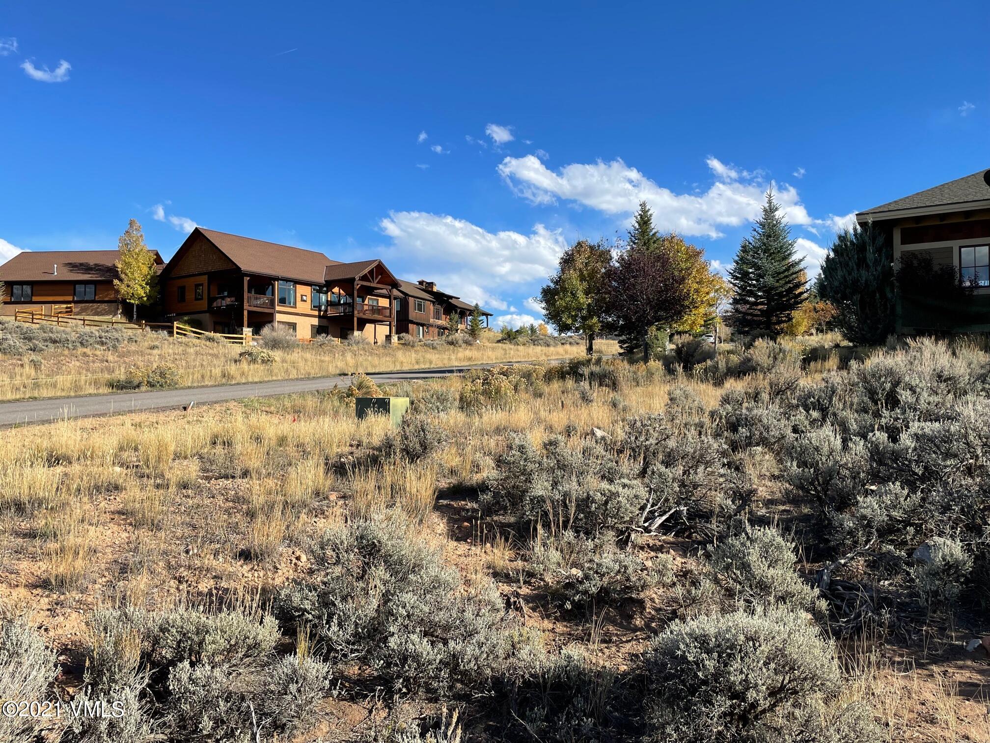 596 4th Of July Road Eagle, CO 81631 - Photo 3 of 4 a view of a lake with a house in the background