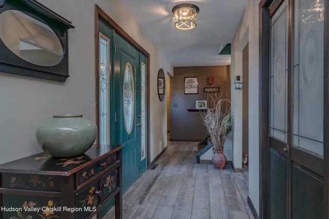 a view of a dining room with furniture a chandelier and wooden floor