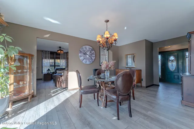 a dining room with furniture potted plants and wooden floor