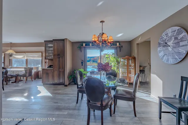 a kitchen with stainless steel appliances granite countertop a table chairs stove and refrigerator