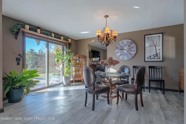 a kitchen with stainless steel appliances granite countertop a stove a refrigerator a oven a sink with a dining table and chairs