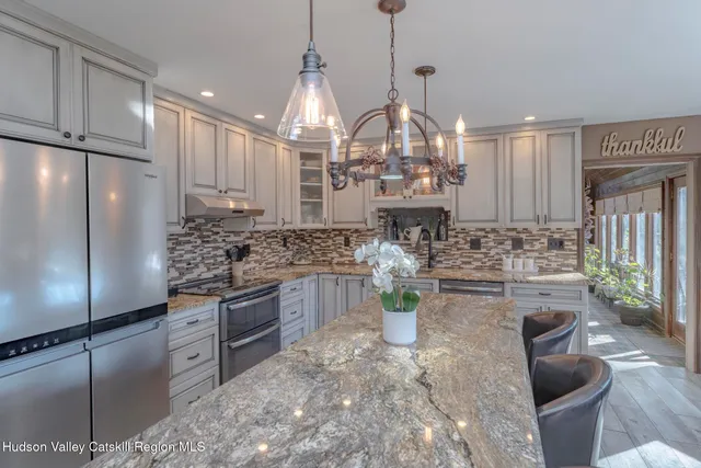 a view of a dining room with furniture wooden floor and chandelier