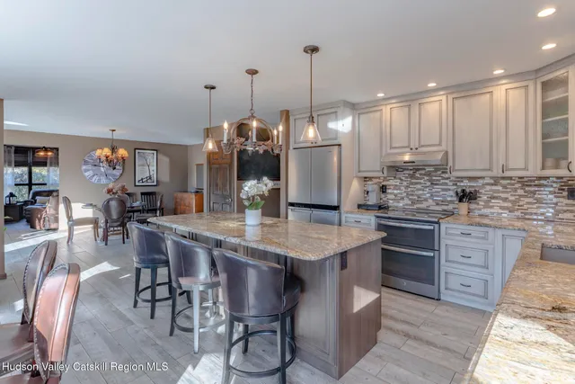 a living room with furniture fireplace and a large window