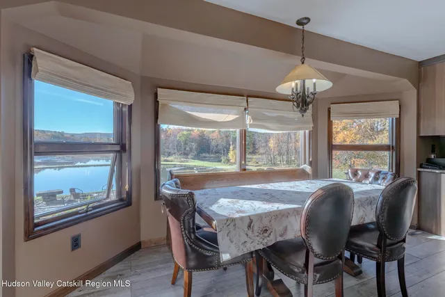 a living room with furniture a flat screen tv and kitchen view