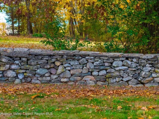 a view of a house with swimming pool and a yard