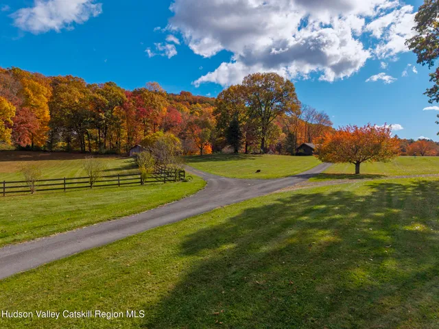 a aerial view of a house with swimming pool next to a big yard