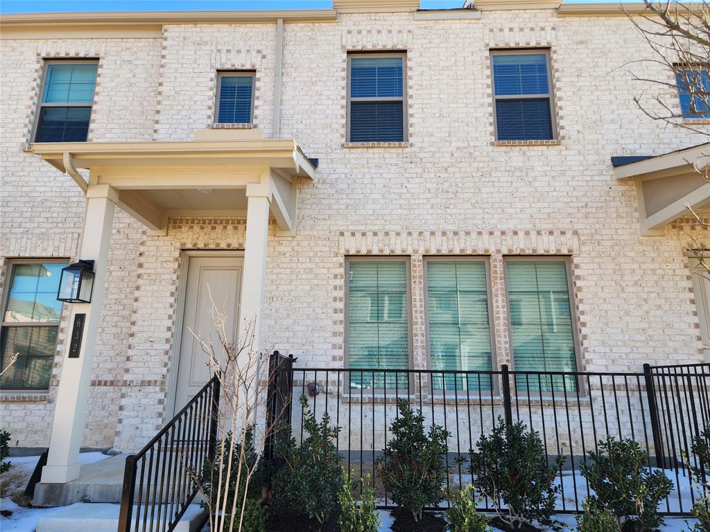 a view of a brick house with many windows