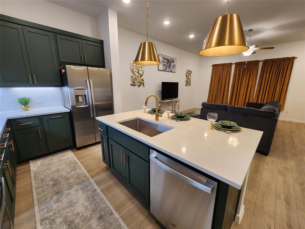 632 Blue Rdg Drive Mansfield, TX 76063 - Photo 16 of 16 a kitchen with a sink a refrigerator and a stove top oven