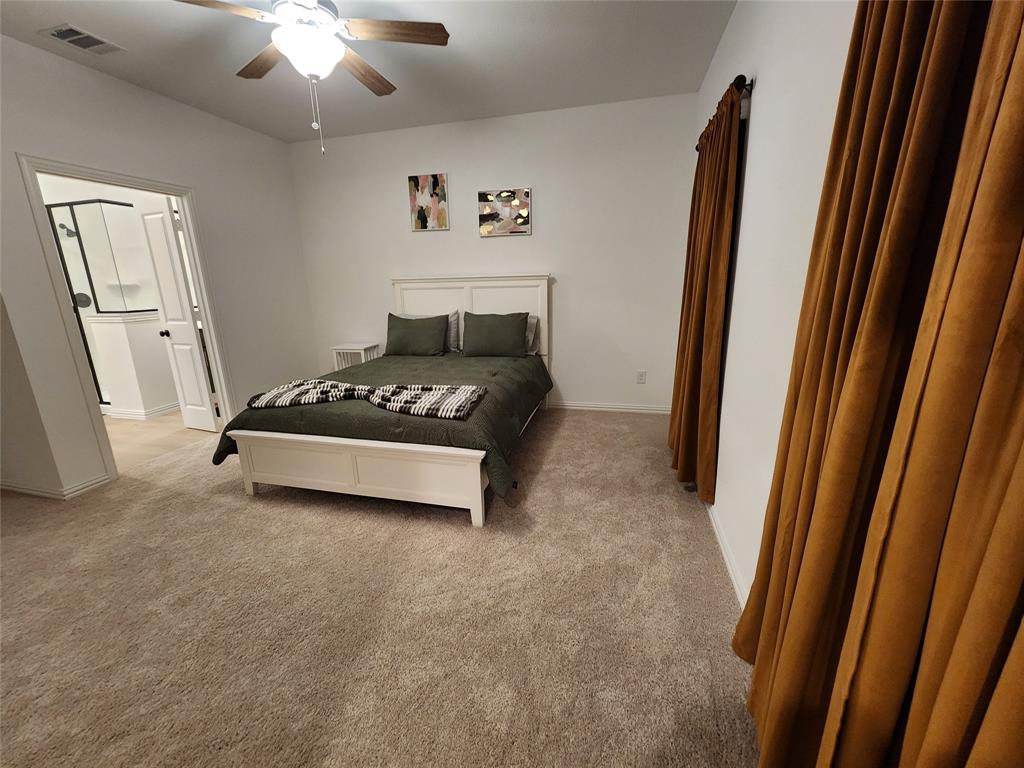 632 Blue Rdg Drive Mansfield, TX 76063 - Photo 9 of 16 a spacious bedroom with a bed and a chandelier