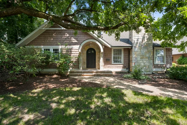 a front view of a house with a garden