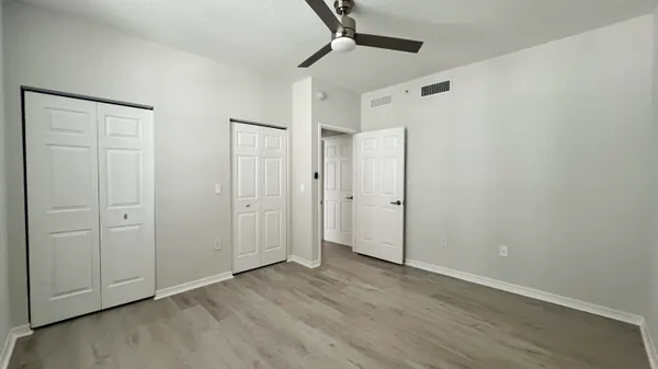 a view of empty room with wooden floor