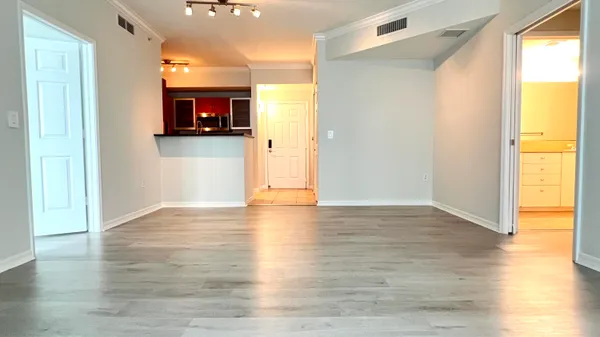 a view of a kitchen with wooden floor and a fireplace