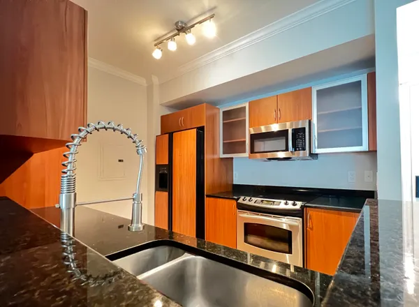 a kitchen with stainless steel appliances granite countertop a stove and a sink