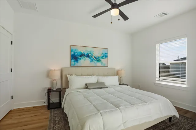 a bedroom with a bed and a painting on the wall