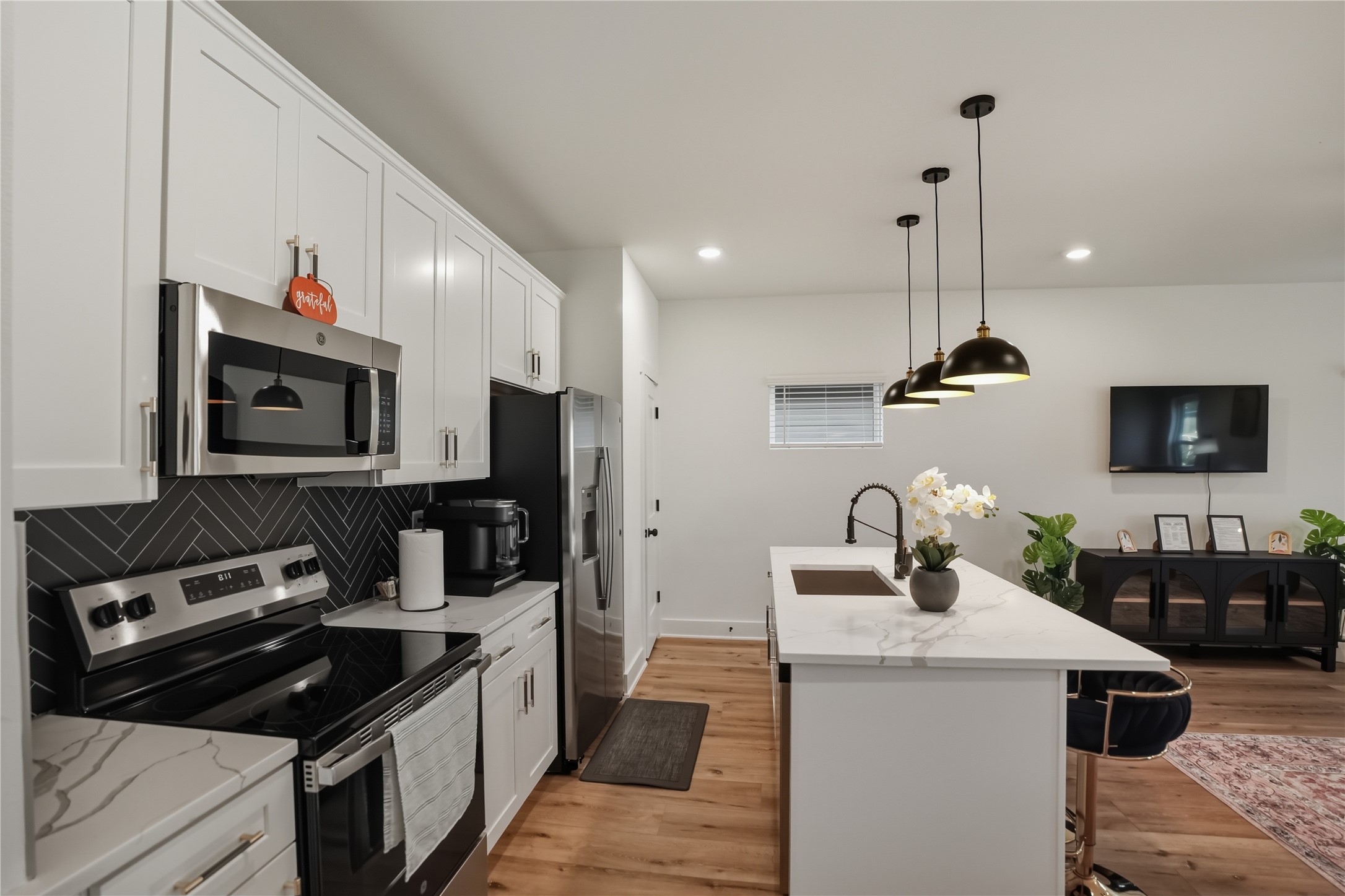 8017 B Cora Street Houston, TX 77088 - Photo 6 of 29 a kitchen with a sink stove and microwave