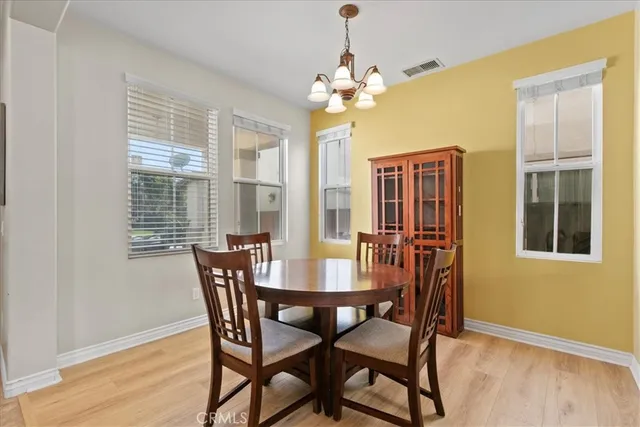 a view of a dining room with furniture and chandelier