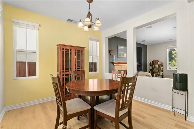 a view of a dining room with furniture and chandelier