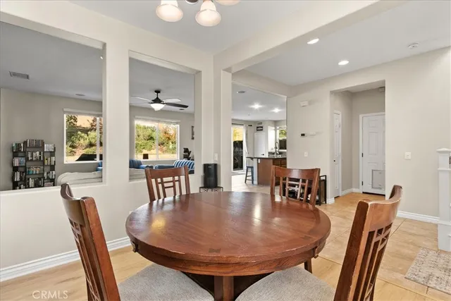 a dining room with furniture a rug and wooden floor