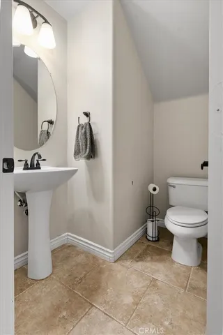 a bathroom with a sink toilet and a mirror