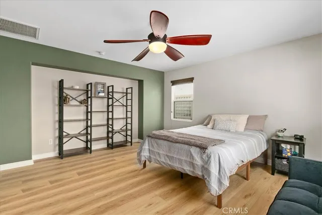 a bedroom with a large bed and a window