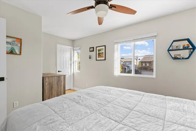 a bedroom with a large bed and a window