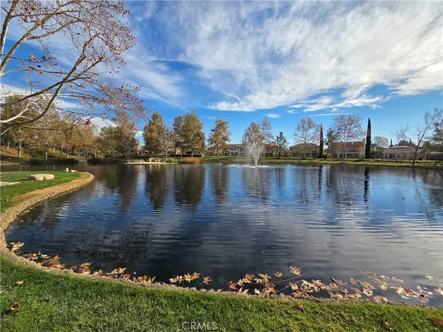 a view of a lake with a yard and green space